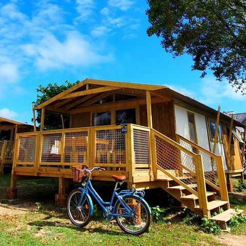 Glampingtent 4 personen - Sweetflower sur pilotis Premium 43m² (2 kamers) inclusief 11m² terras + TV + Bedlinnenpakket en handdoeken